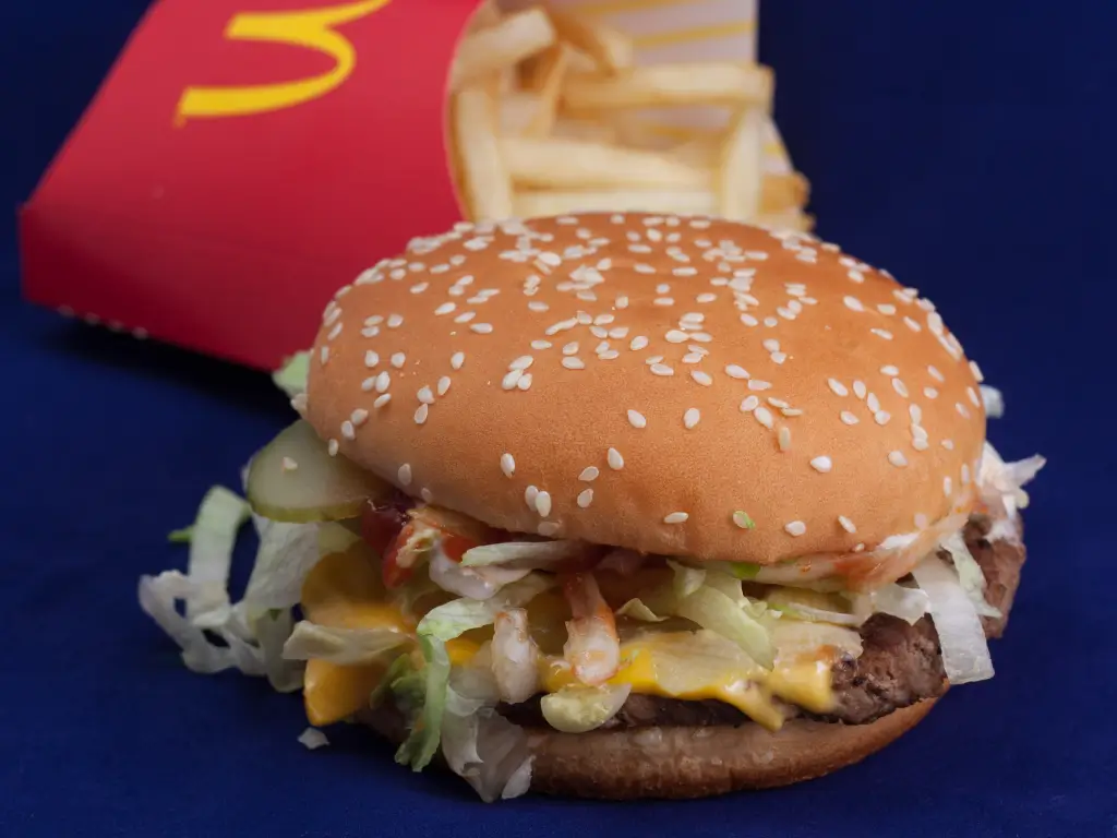 Quarter pounder with cheese, fries, and a drink arranged at a McDonald's in California