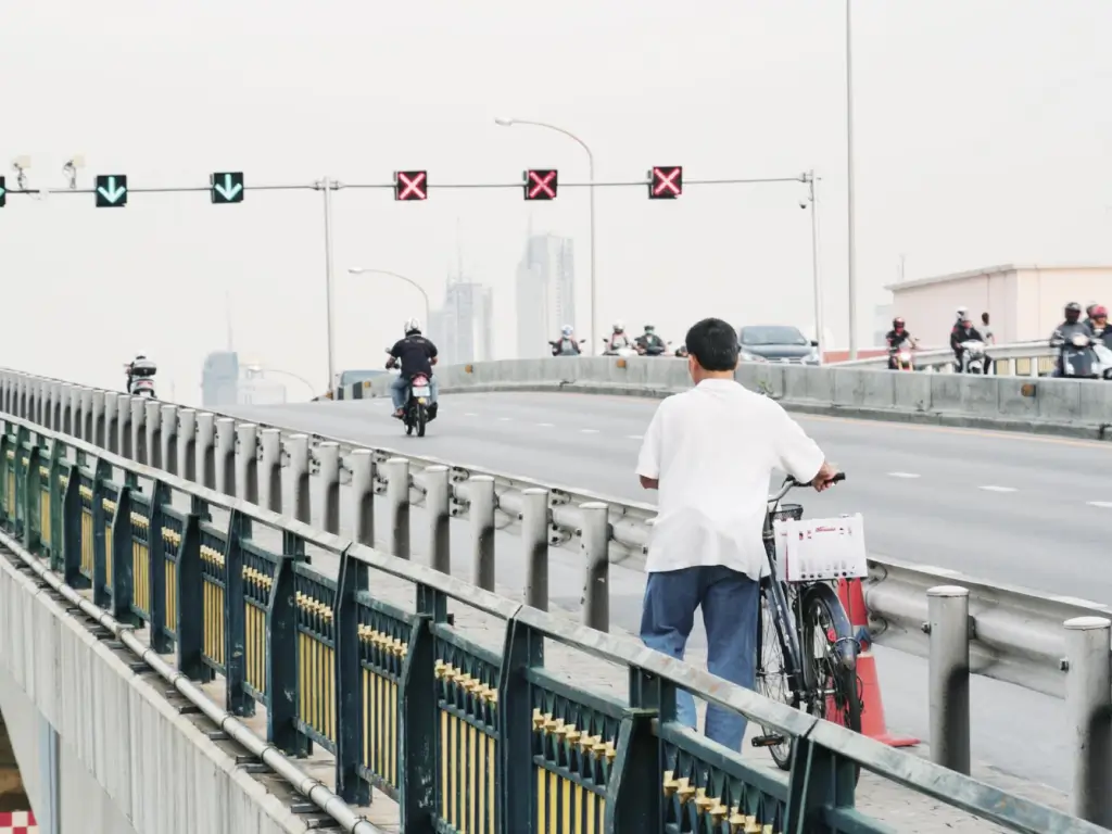 north korean people on road with bicycle