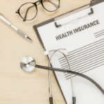 A stethoscope resting on a health insurance policy document symbolizing the role of insurance in healthcare