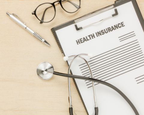 A stethoscope resting on a health insurance policy document symbolizing the role of insurance in healthcare