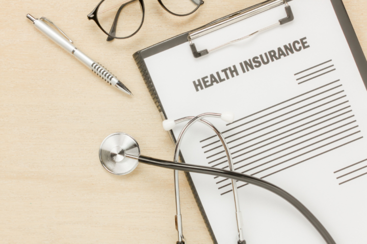 A stethoscope resting on a health insurance policy document symbolizing the role of insurance in healthcare