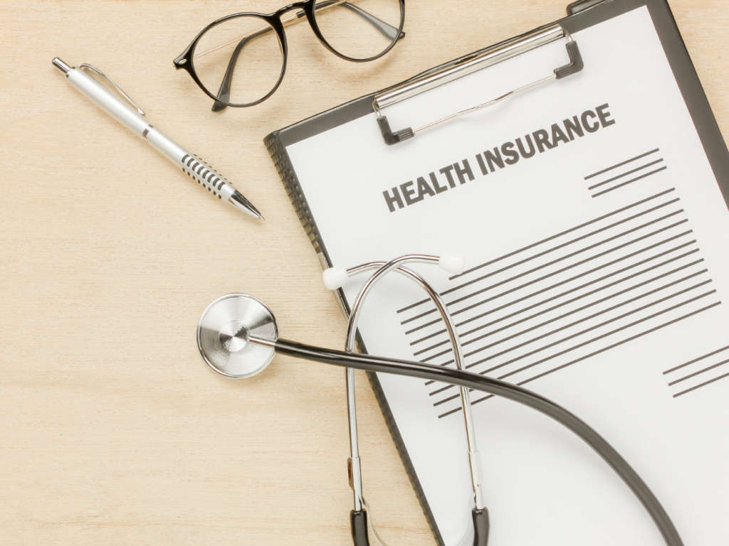 A stethoscope resting on a health insurance policy document symbolizing the role of insurance in healthcare